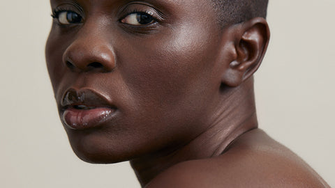 a woman's profile looking into the camera
